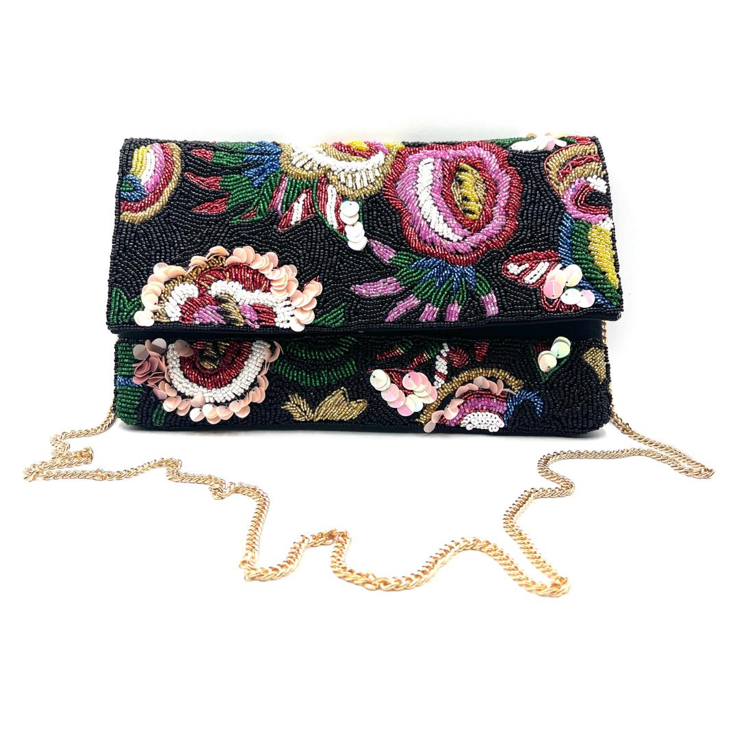 Embroidered clutch bag with floral patterns on a white background