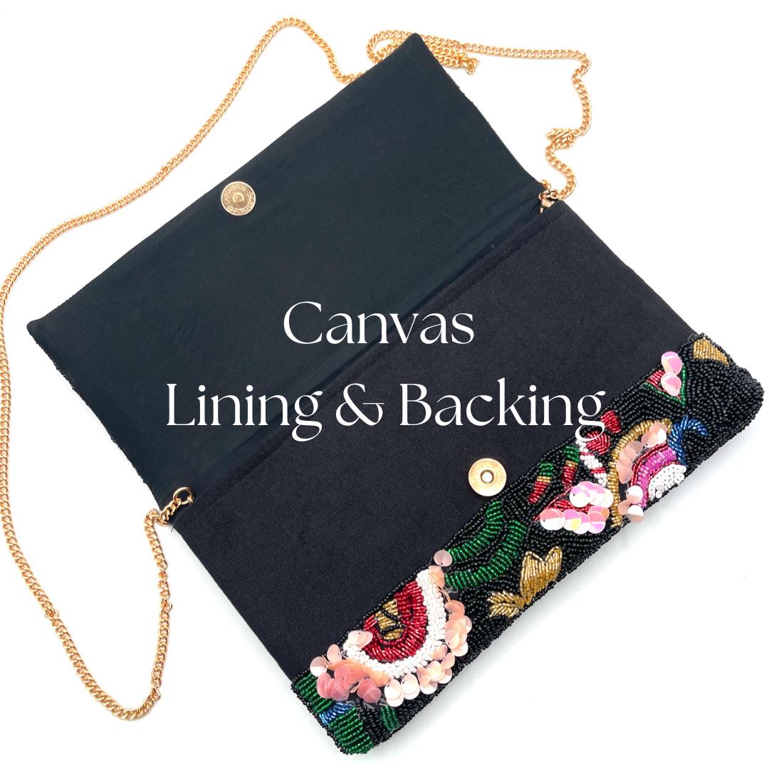 Black clutch with floral embroidery and gold chain strap on a white background