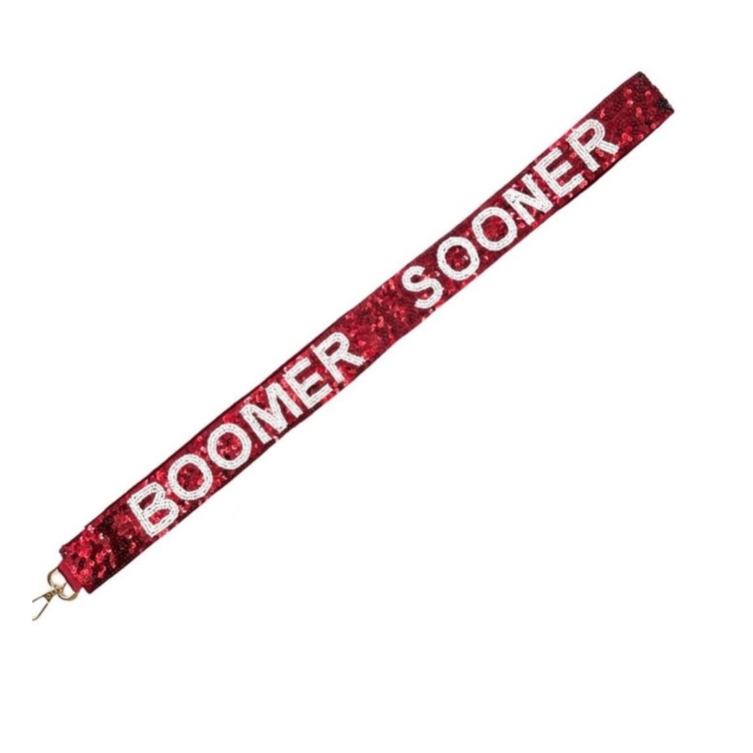 Red glittery lanyard with 'Boomer Sooner' text on a white background