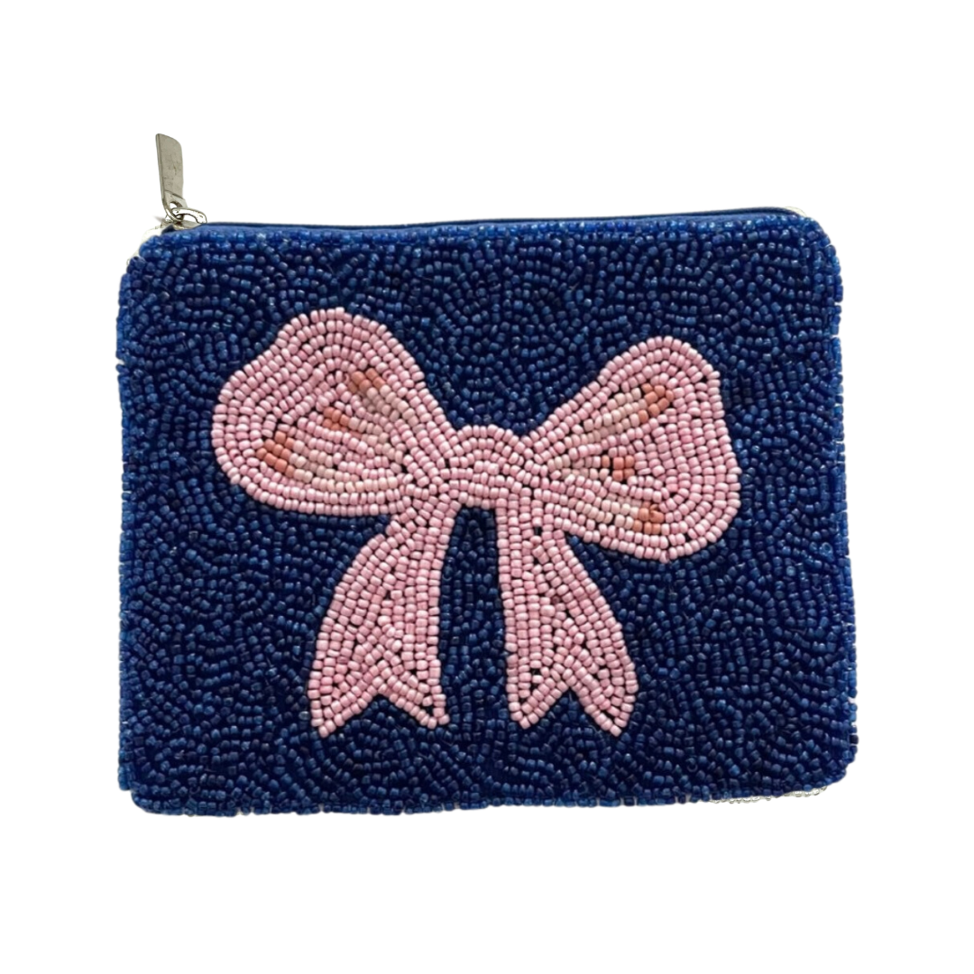 Navy blue beaded pouch with a pink bow on a white background