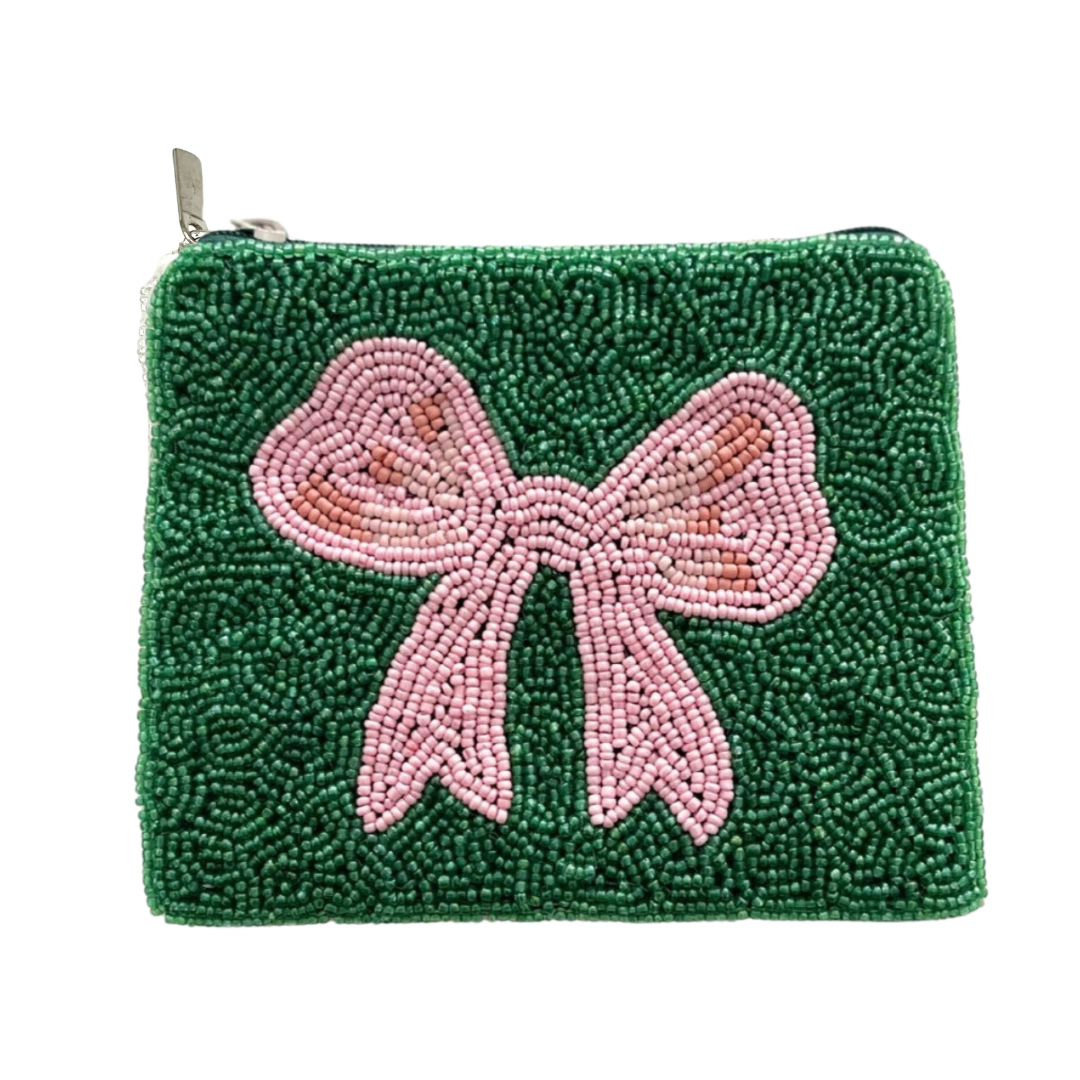 Green beaded pouch with a pink bow on a white background