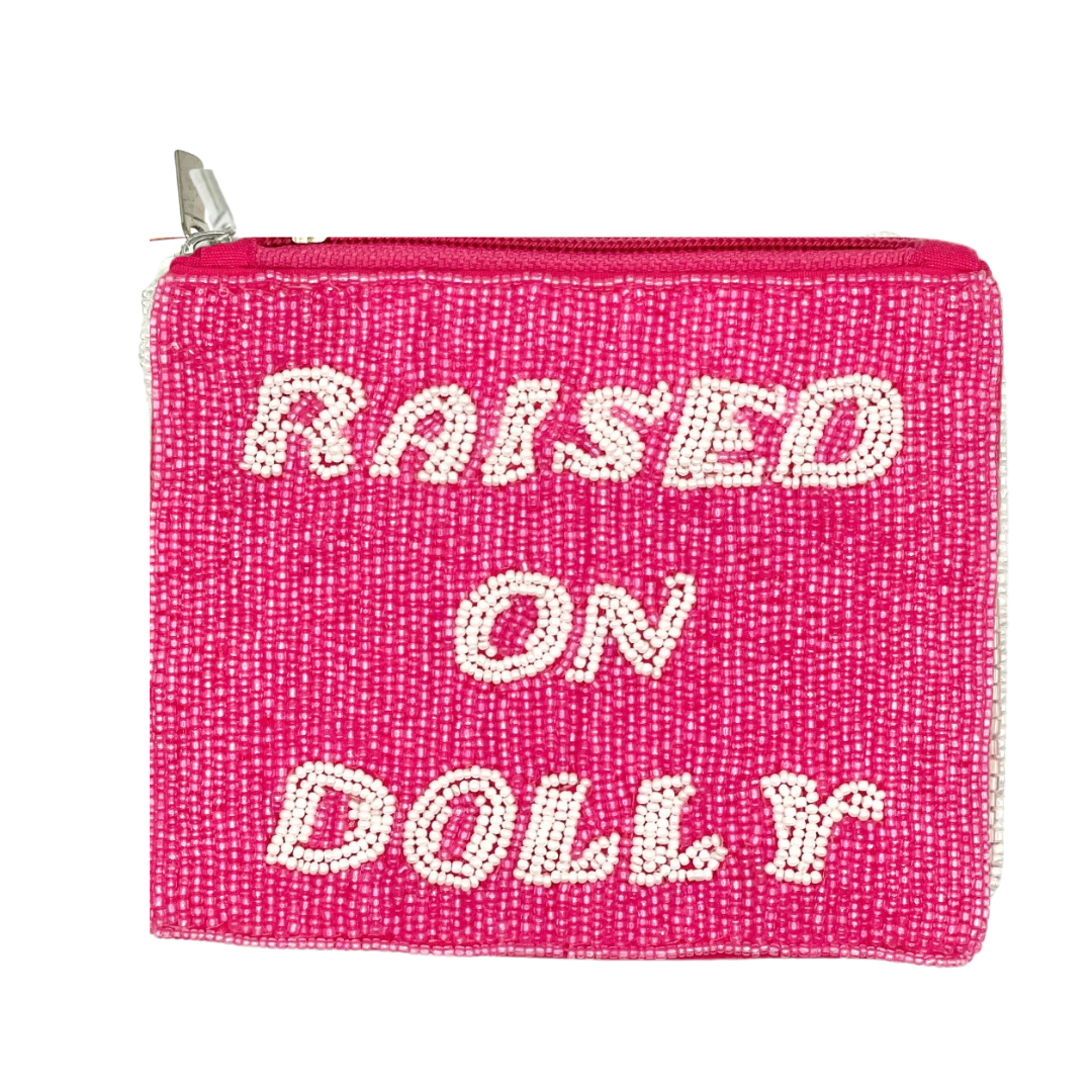 Pink pouch with 'Raised on Dolly' text on a white background