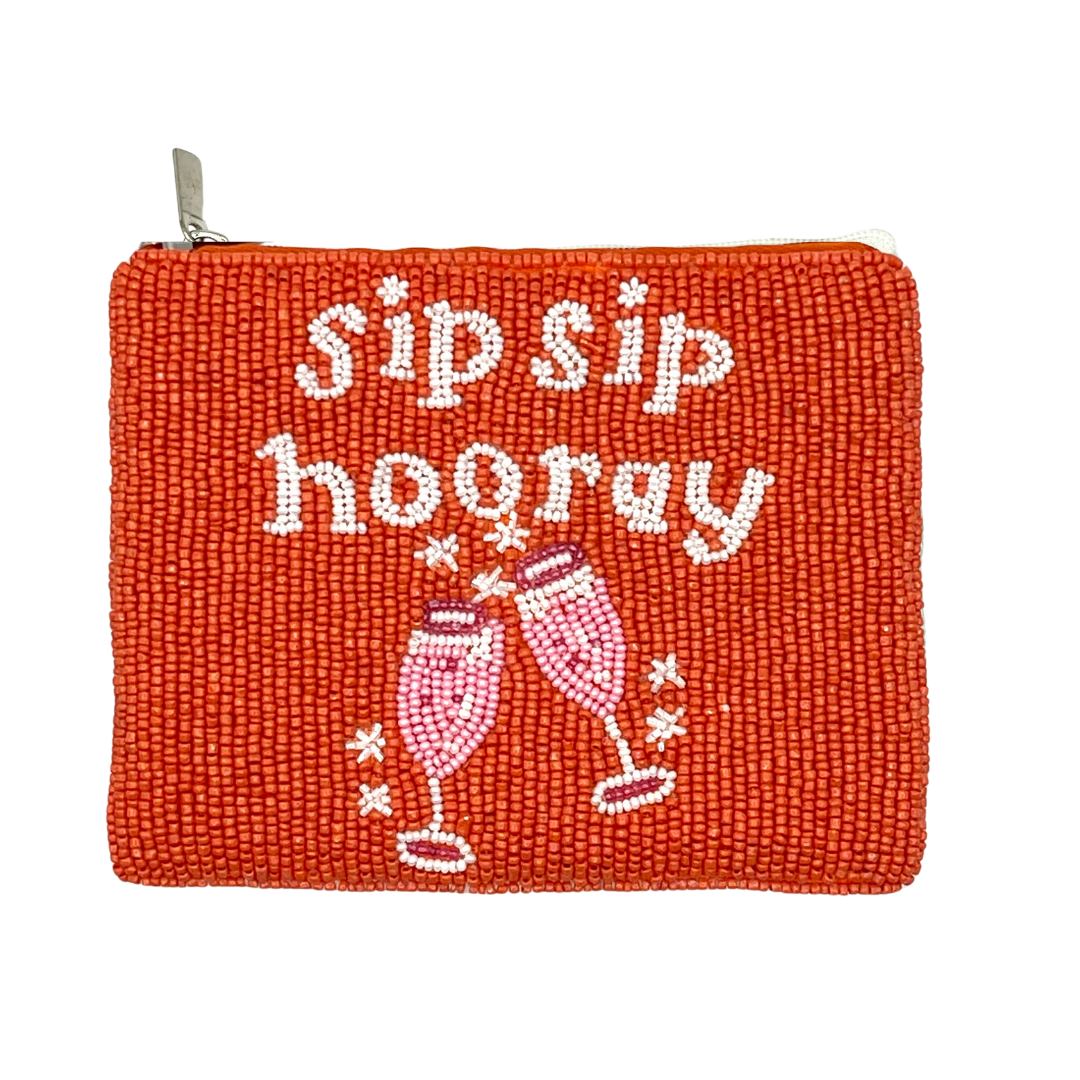 Red pouch with 'sip sip hooray' text and champagne glass design on a white background