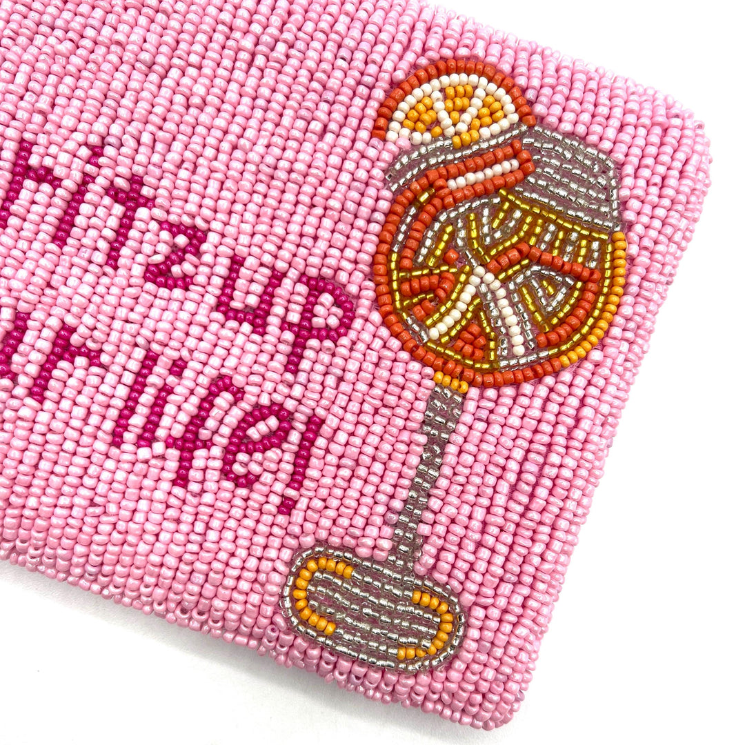 Pink beaded pouch with flamingo design and text on a white background