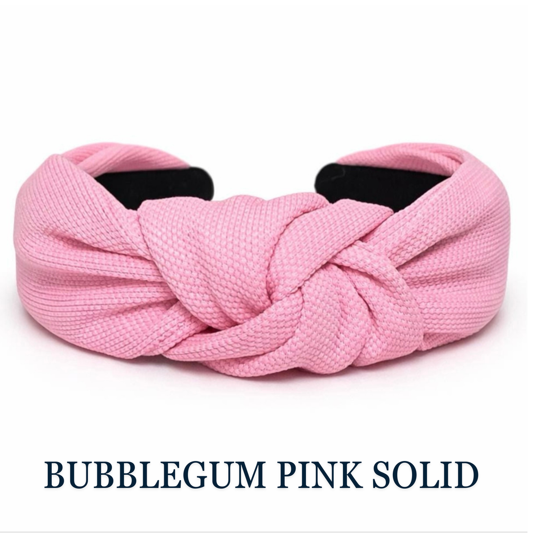 Pink knotted headband on a white background with 'Bubblegum Pink Solid' text.