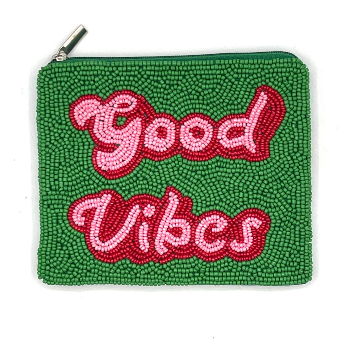 A small beaded coin purse with green and red seed beads, featuring the text 'GOOD VIBES' on the front.