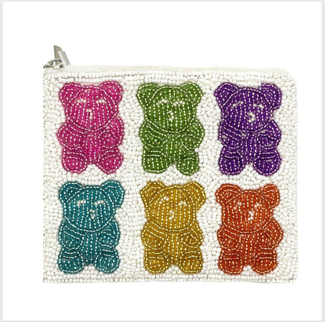 A multicolored beaded coin purse in the shape of gummy bears, with a zipper closure and a canvas backing.