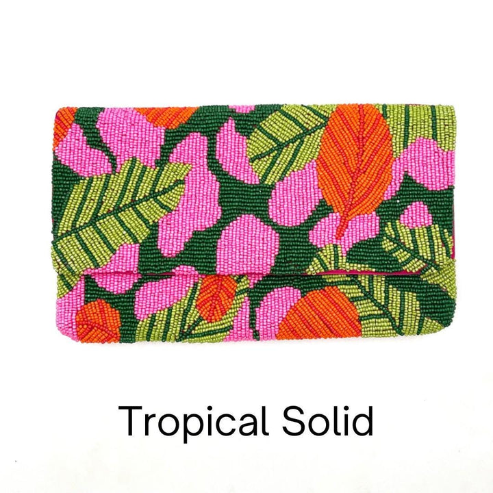 Colorful clutch with tropical leaf pattern on a white background