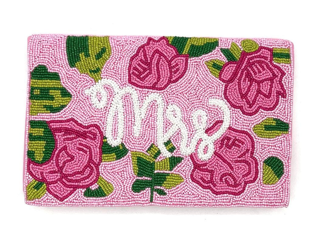 Pink clutch with floral design and &