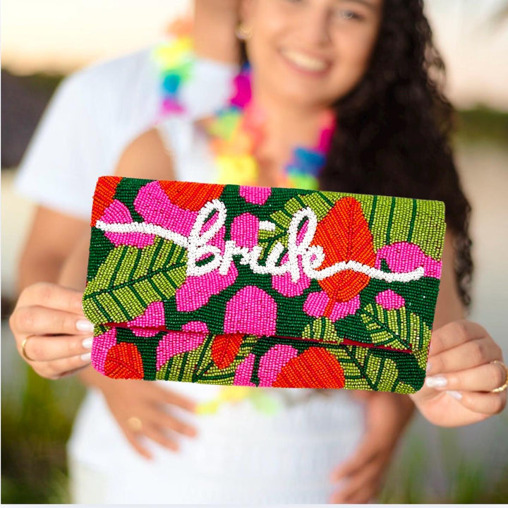 Person holding a colorful clutch with &