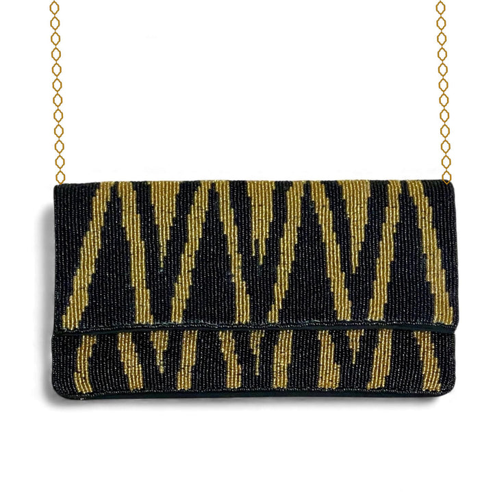Black and gold beaded clutch bag with a chain strap on a white background