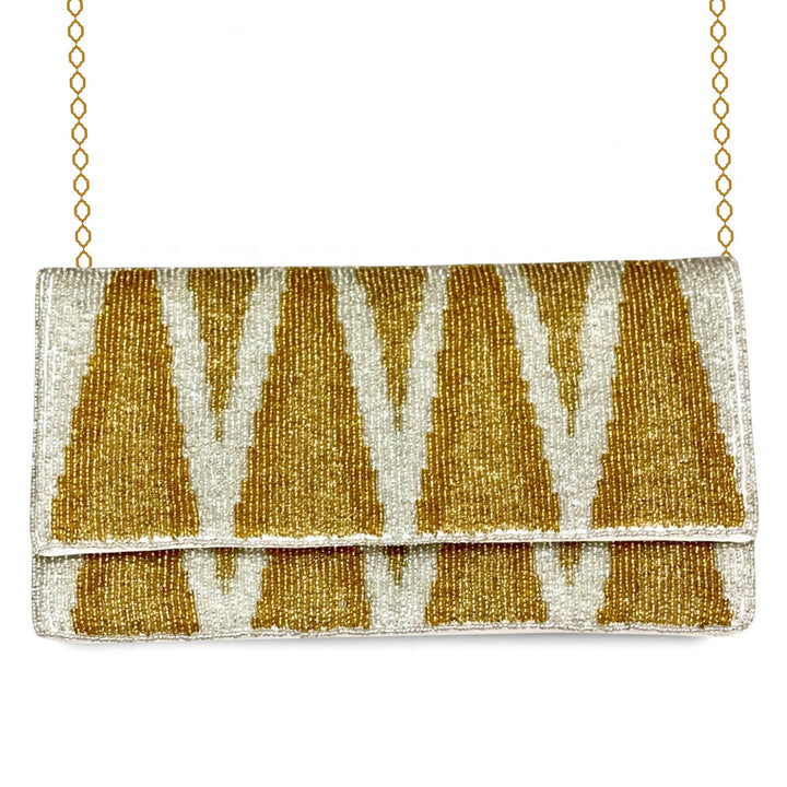 Gold and white beaded clutch bag on a white background