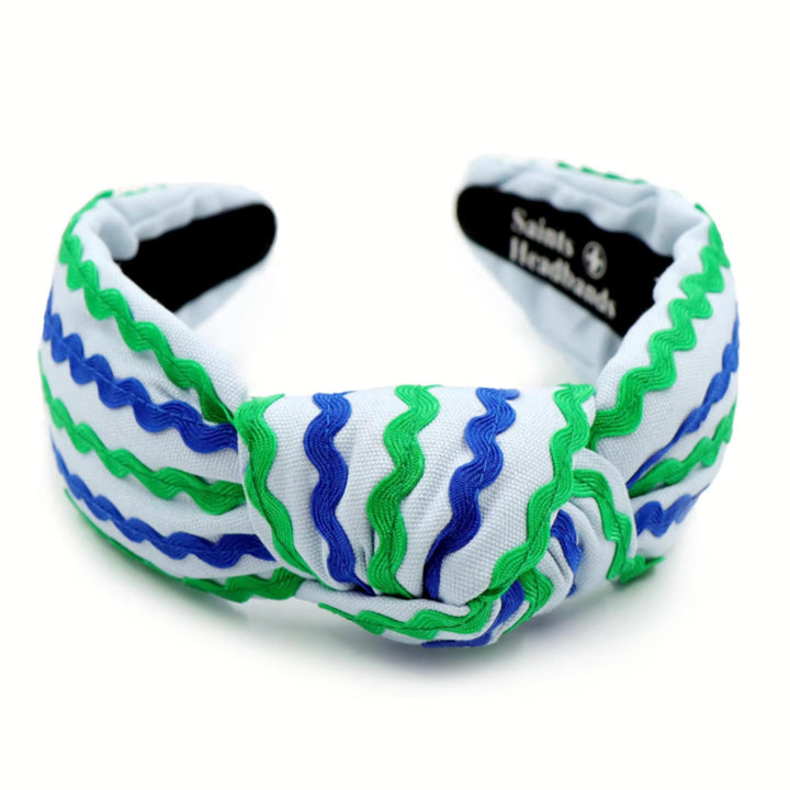 White headband with blue and green wavy patterns on a white background