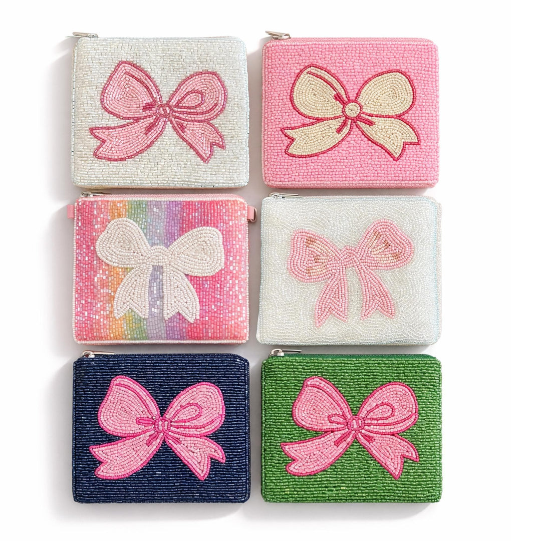 Set of six small pouches with bow designs on a white background