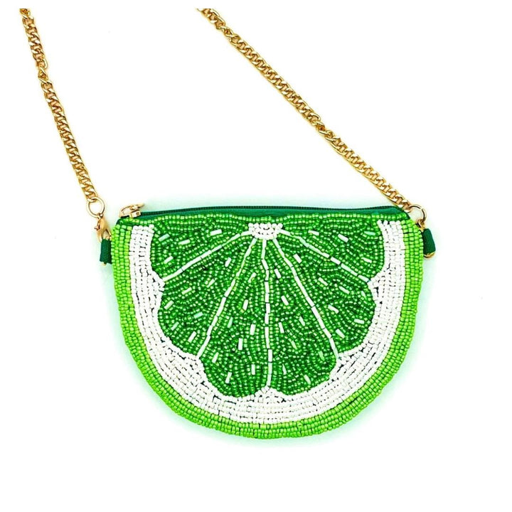 Beaded lime-shaped handbag with a gold chain on a white background