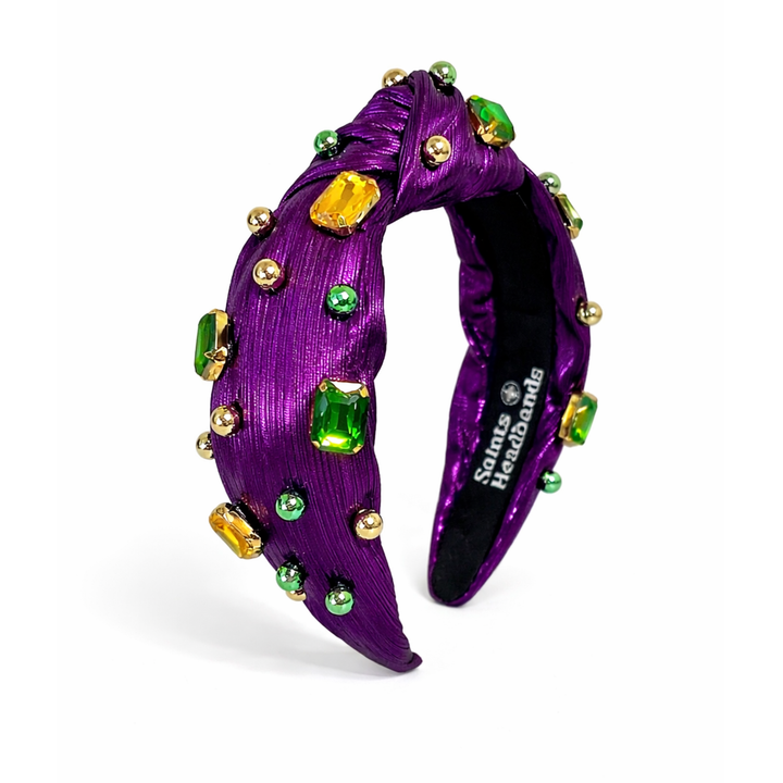 purple headband with gold jewels, green jewels and gold and green pearls.