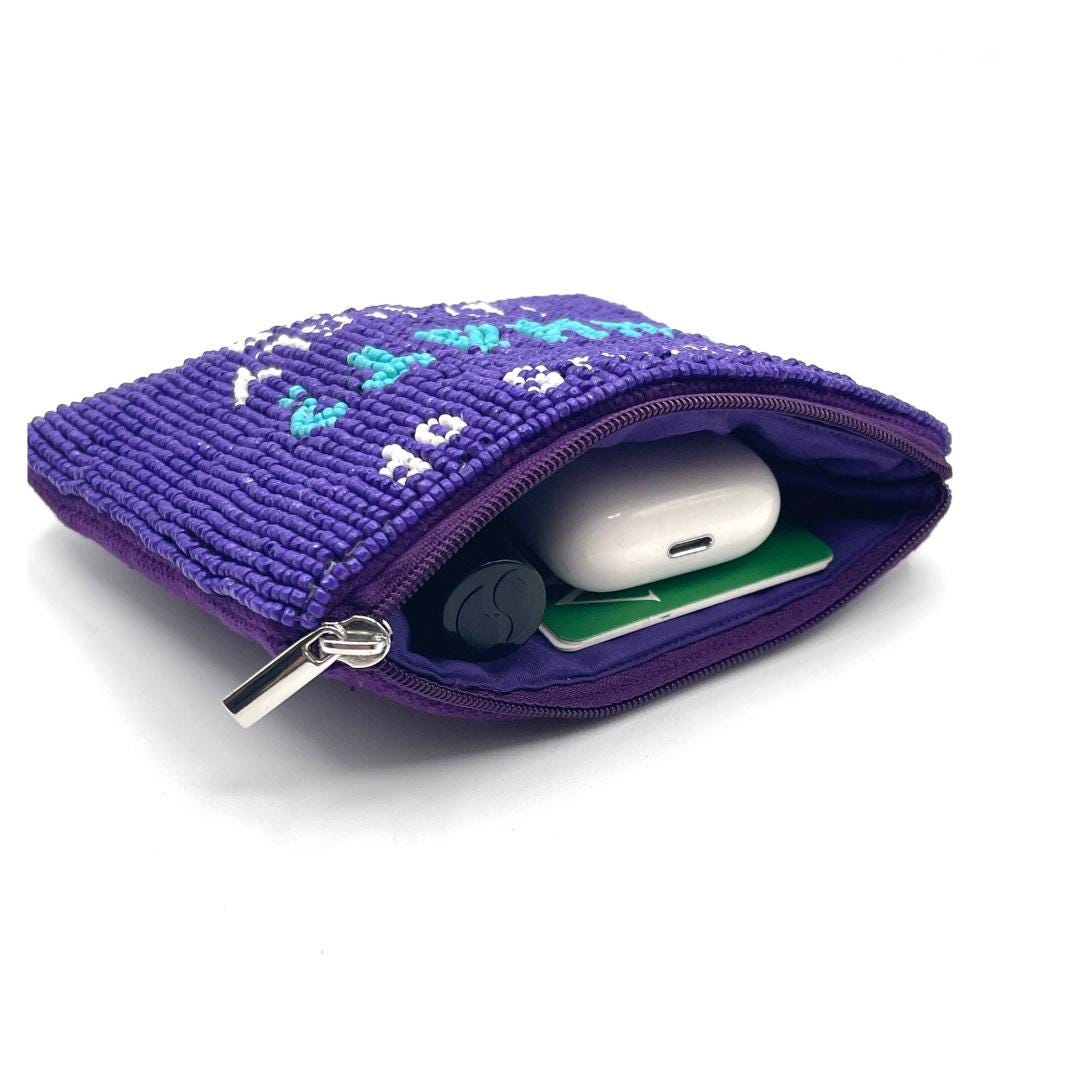 Purple textured pouch with a white electronic device inside on a white background