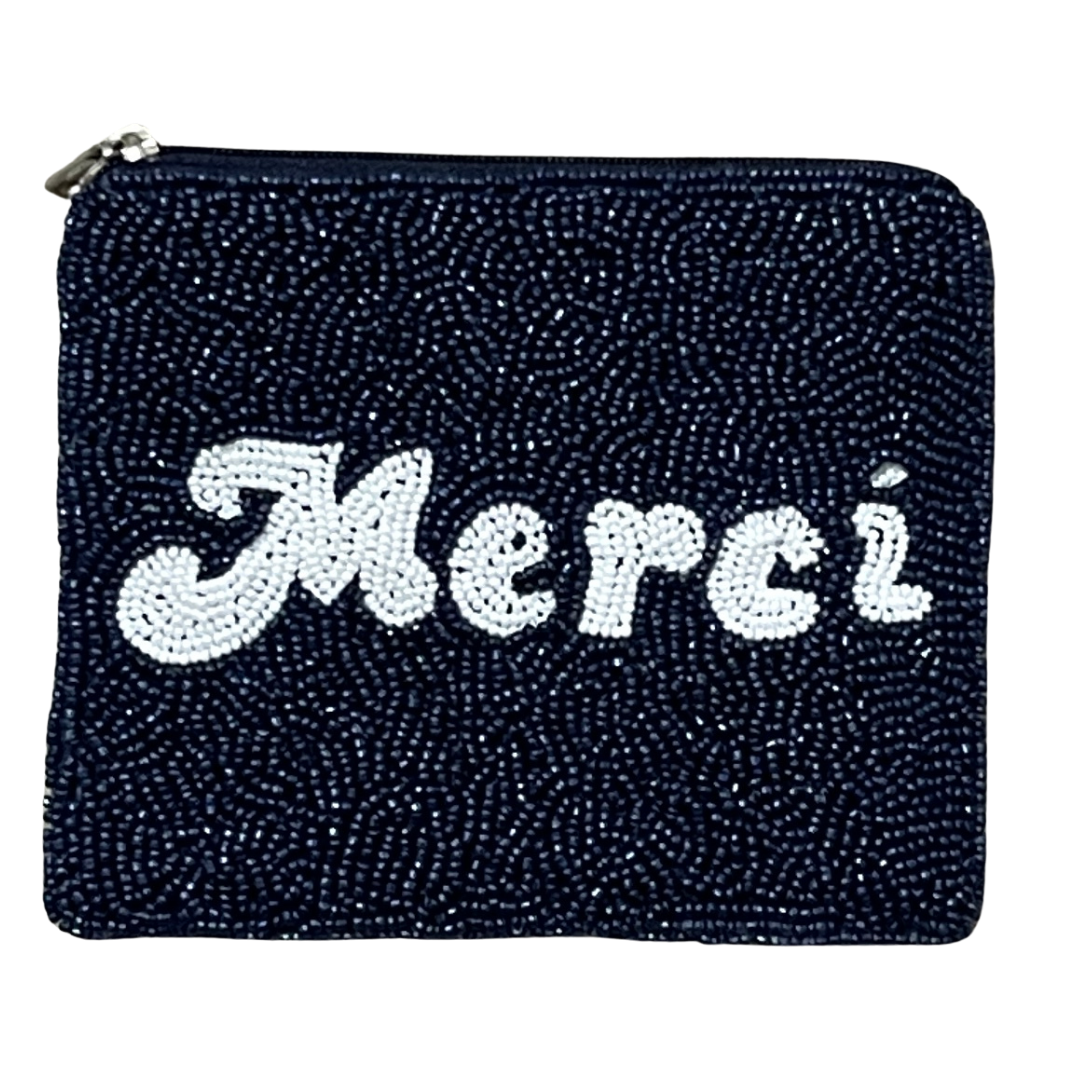 Black glittery pouch with 'Merci' in white beads on a white background