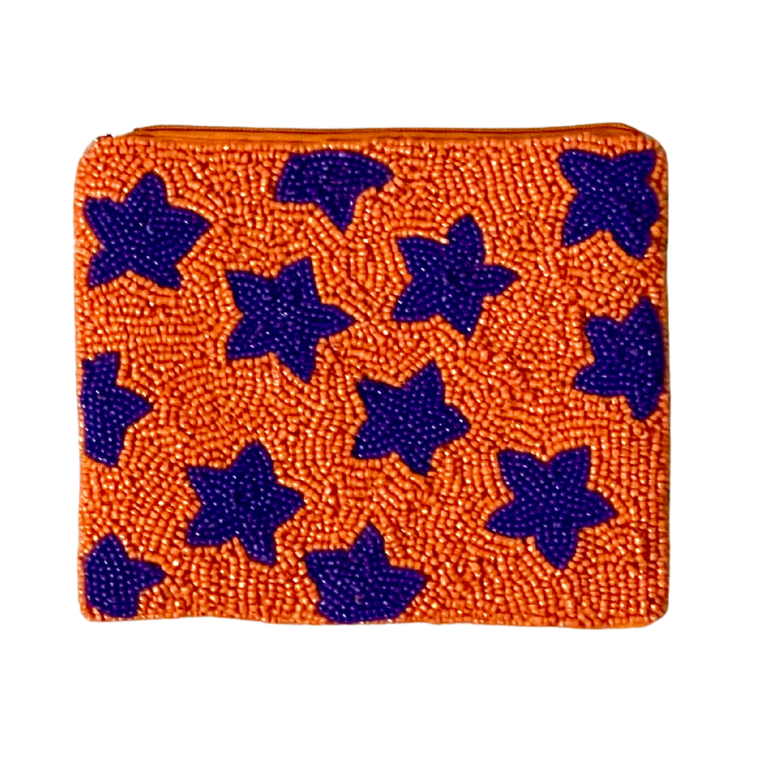 Orange clutch with blue star patterns on a white background