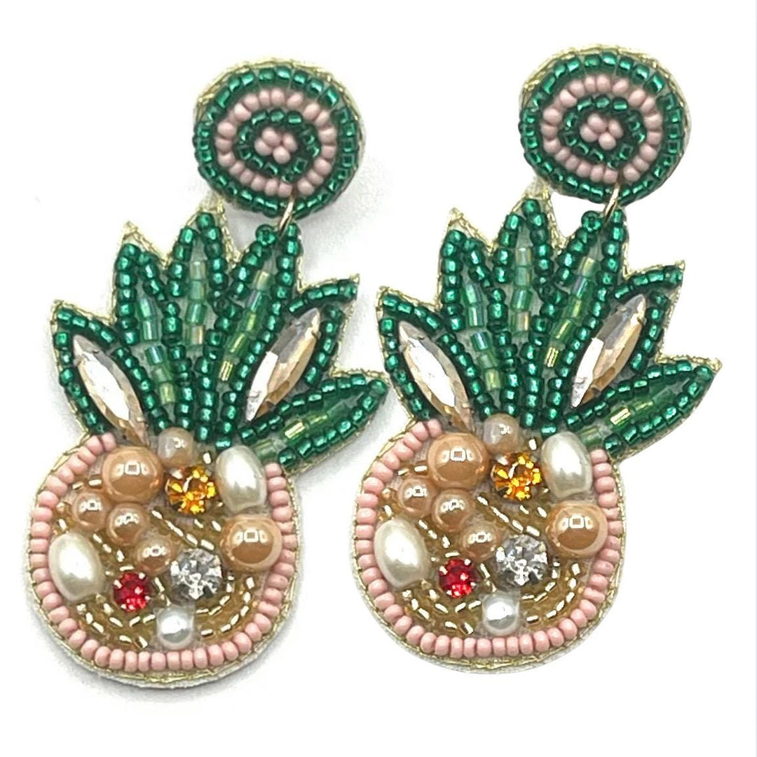 Pineapple-shaped earrings with green, pink, and gold beads on a white background