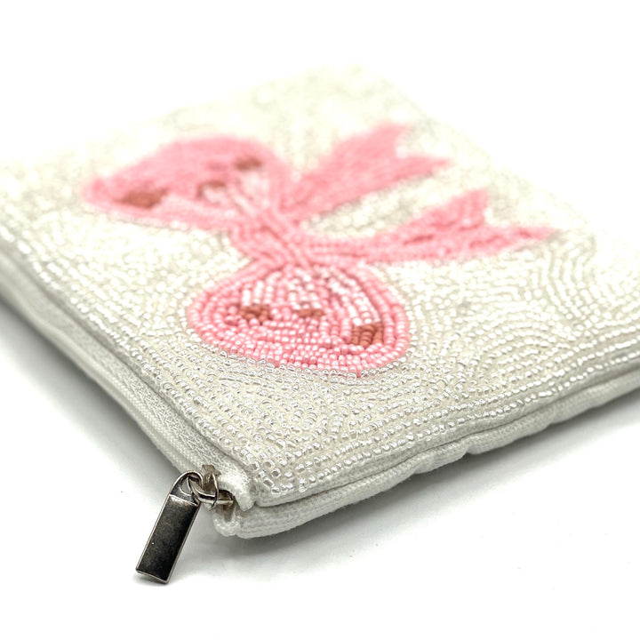 White beaded pouch with pink butterfly design on a white background