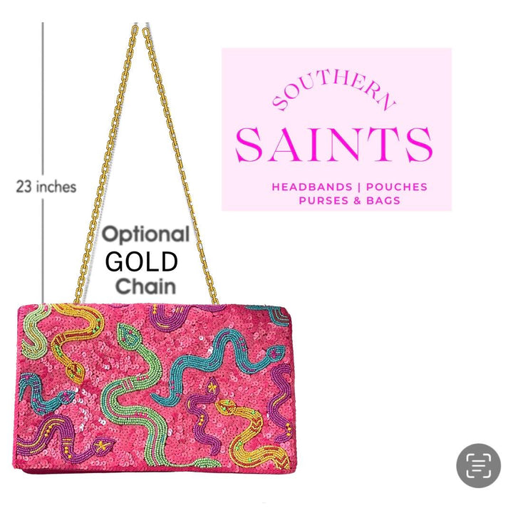 Pink clutch bag with snake designs and gold chain, branded 'Southern Saints'.