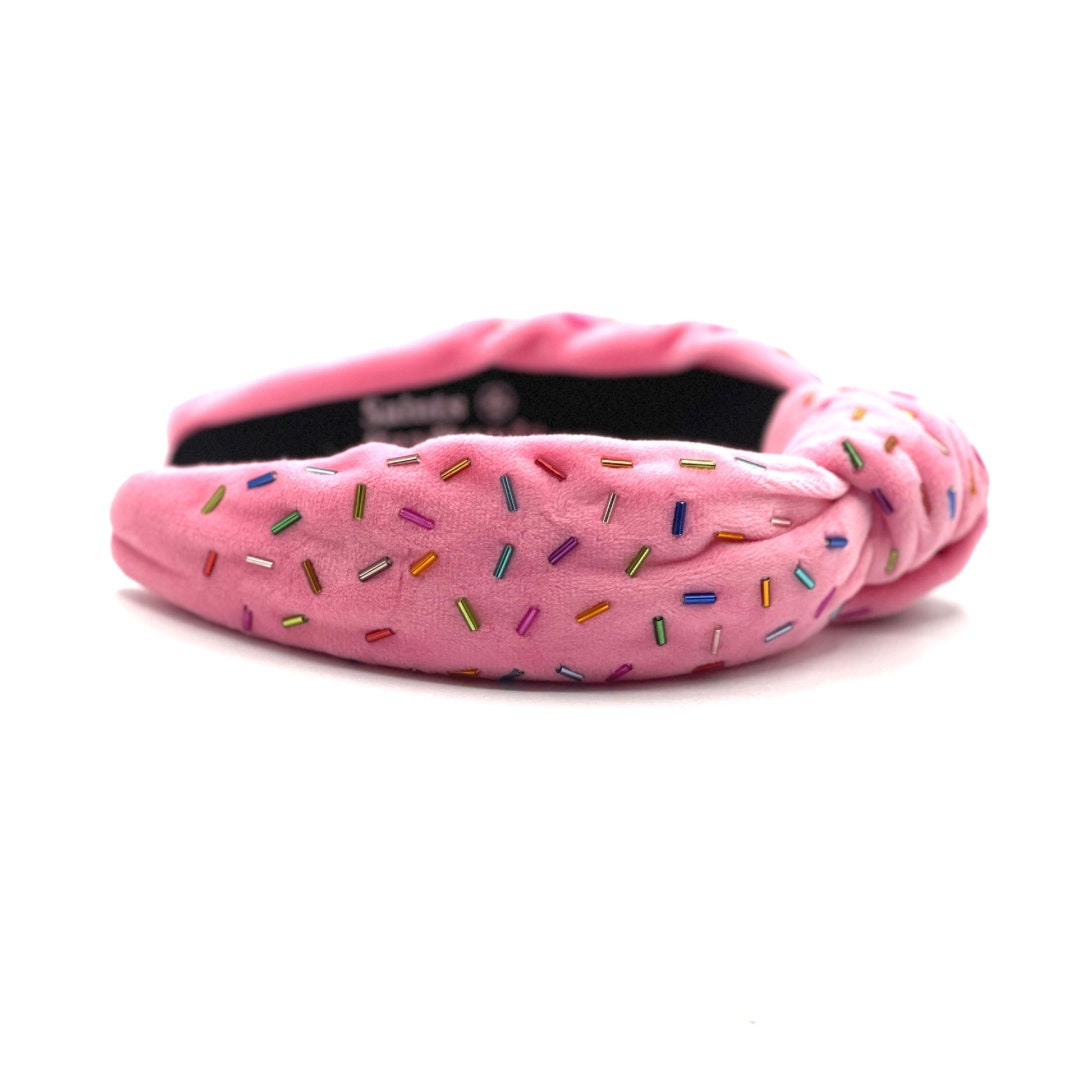 Pink headband with colorful sprinkles on a white background