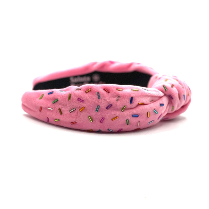 Pink headband with colorful sprinkles on a white background