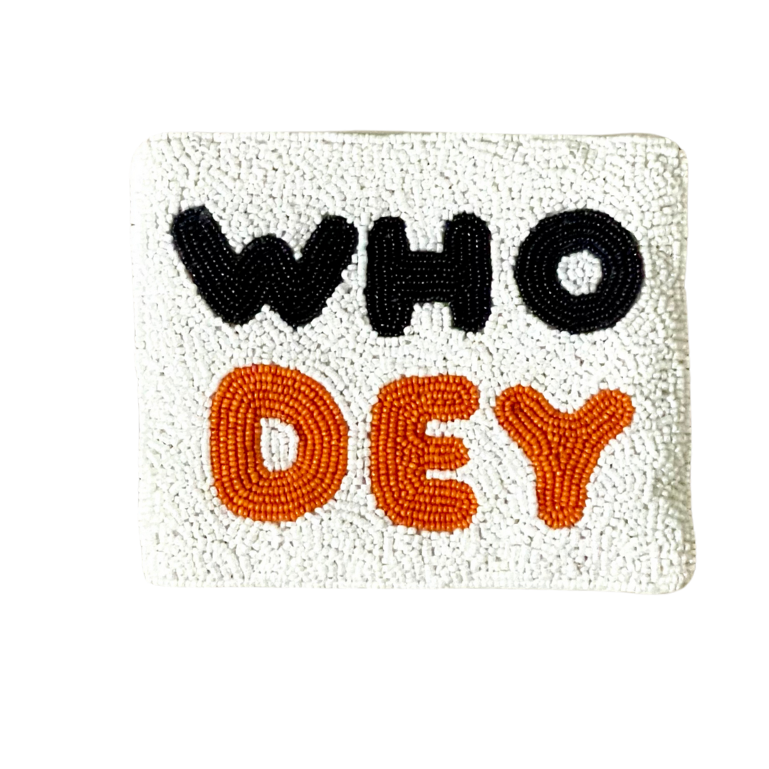 Text 'WHO DEY' on a textured surface with black and orange letters