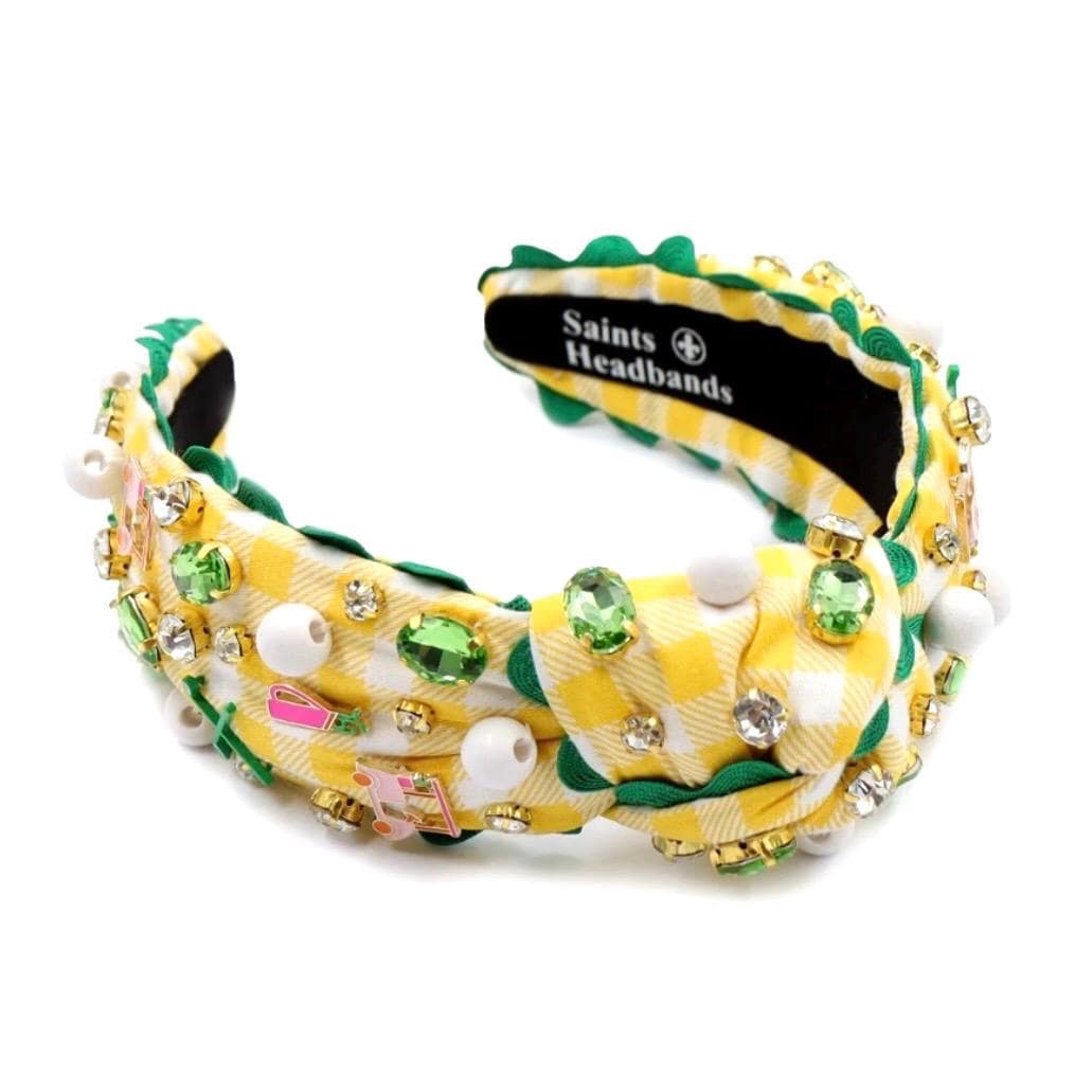 Decorative headband with green, yellow, and white colors on a white background