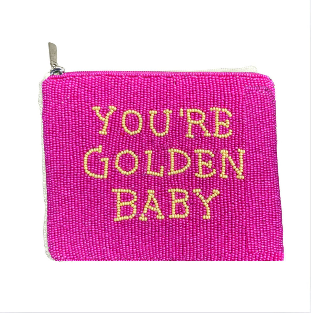 A pink beaded coin purse with the text 'You're Golden Baby' written in yellow.